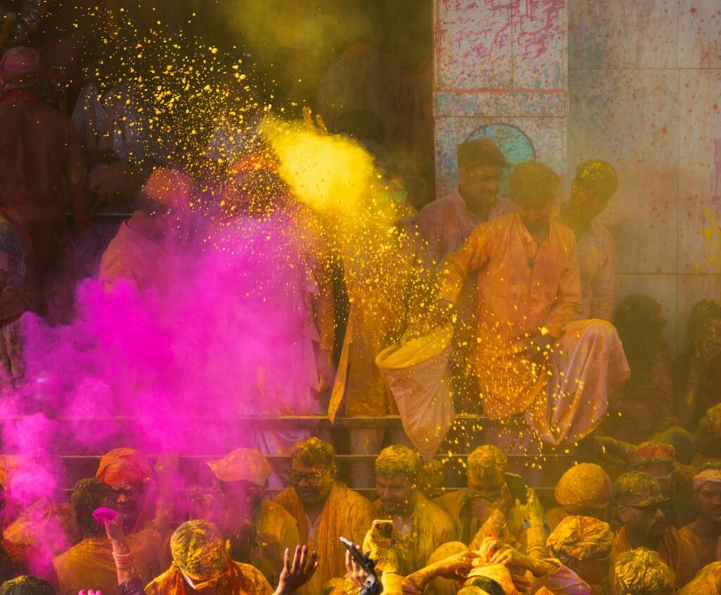 a group of people celebrating holi with colored powder