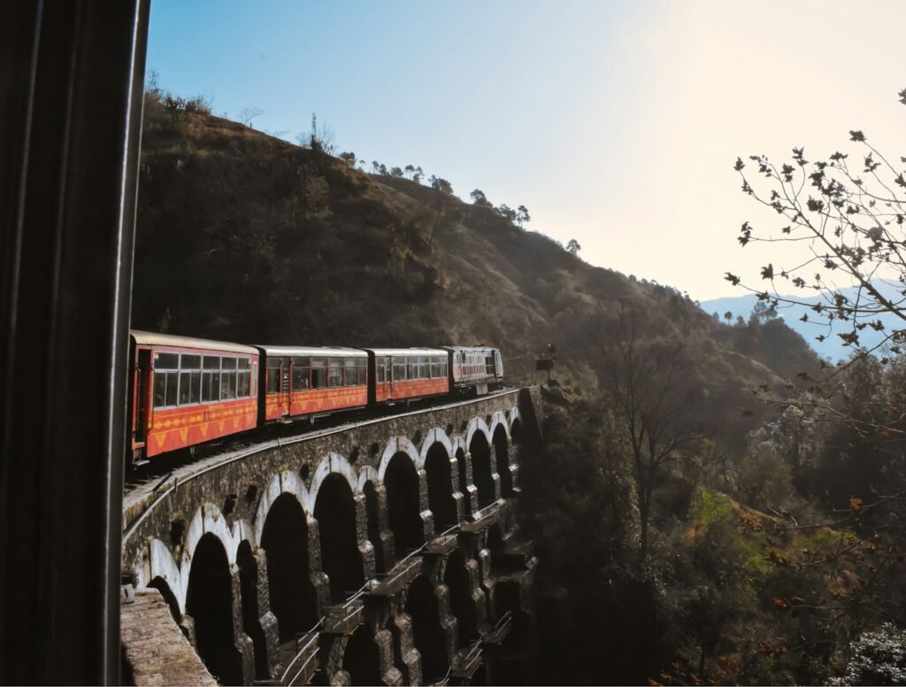 a train traveling over a bridge in the mountains