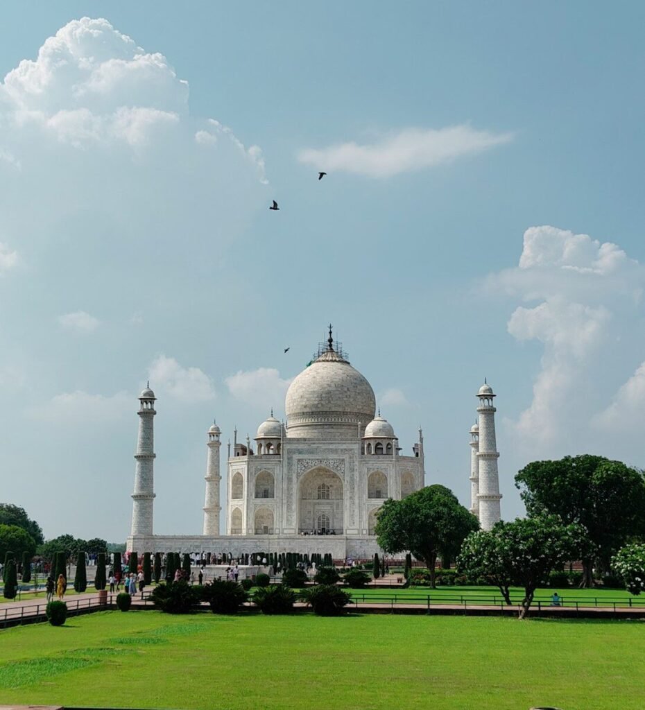 The taj mahal stands majestically under a blue sky.